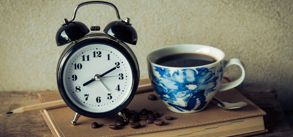Psychologists off the Clock Banner Image - An old fashioned alarm clock and a cup of delicious coffee